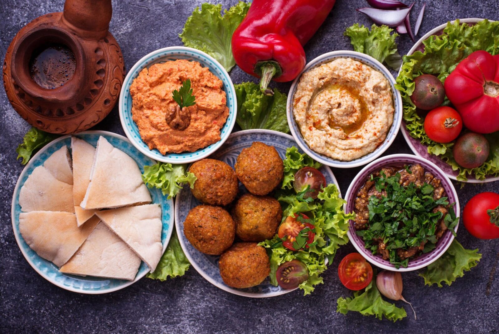 Selection of Middle eastern or Arabic dishes. Falafel, hummus, pita and muhammara. Top view