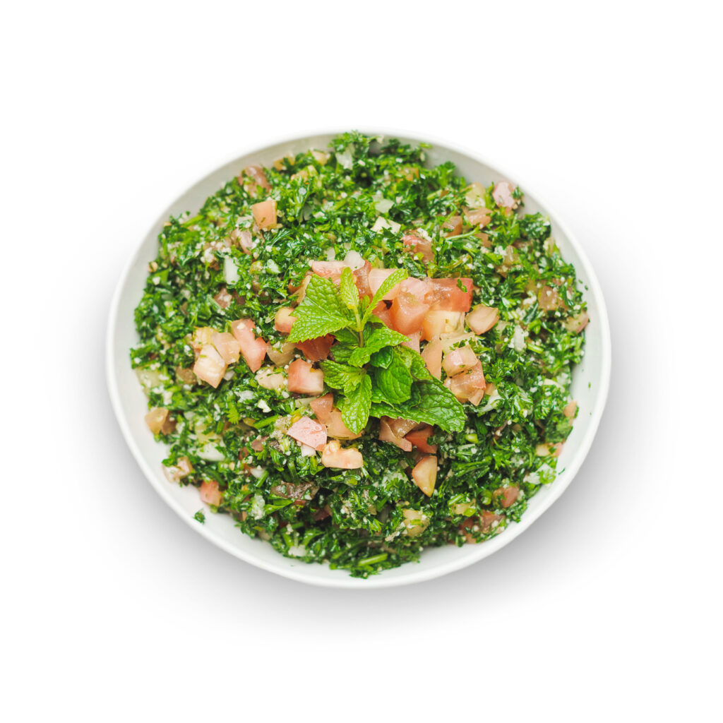 Freshly prepared Tabouli from Aladdin Mediterranean Cuisine, featuring chopped parsley, tomatoes, mint, and bulgur, seasoned with olive oil and lemon.A staple in the Mediterranean Diet