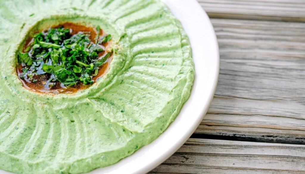 Spinach hummus served at Aladdin Mediterranean Cuisine in Houston — a creamy blend of chickpeas, tahini, olive oil, and fresh spinach.