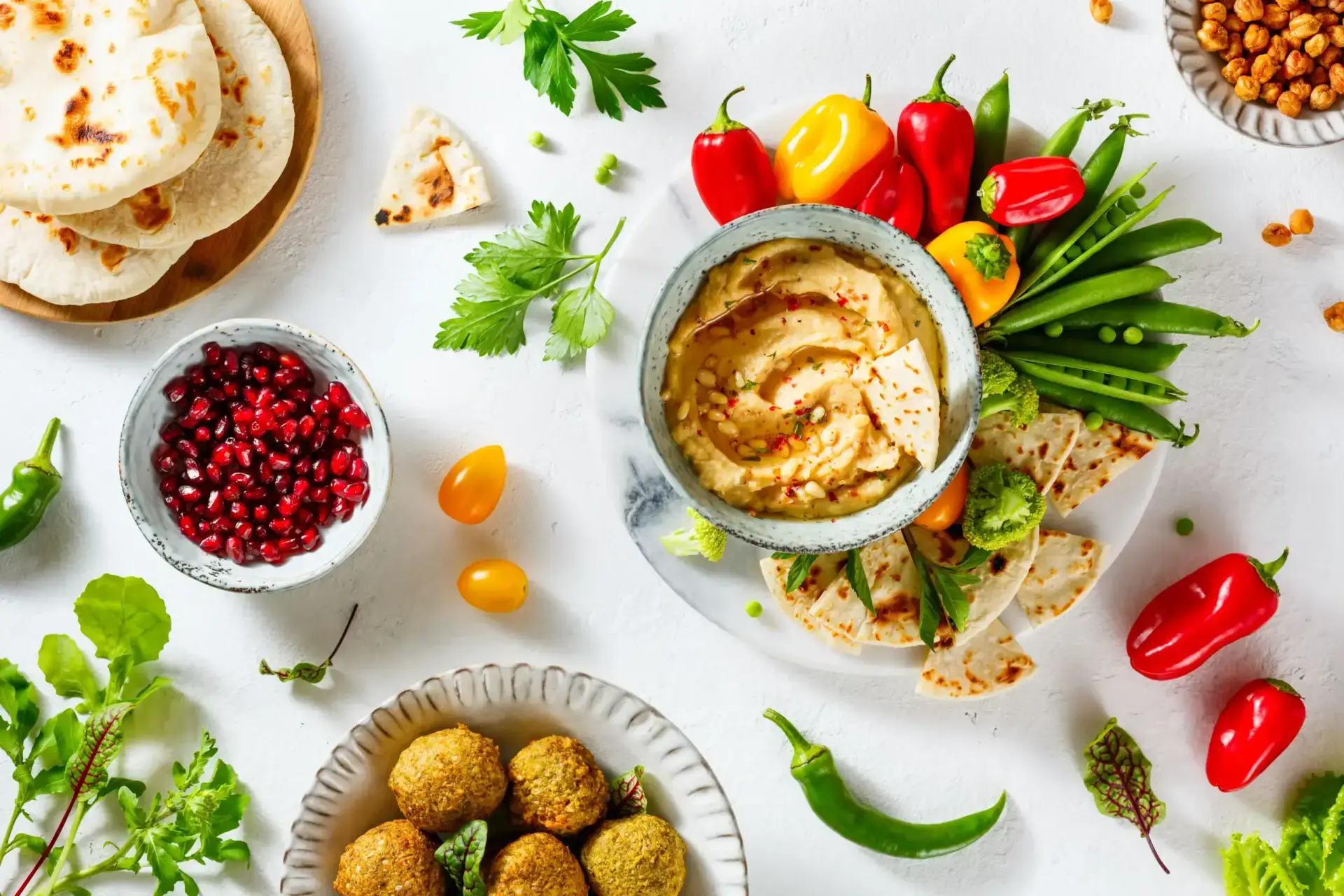 Vibrant Mediterranean catering setup with kabobs, hummus, and fresh salads in Houston