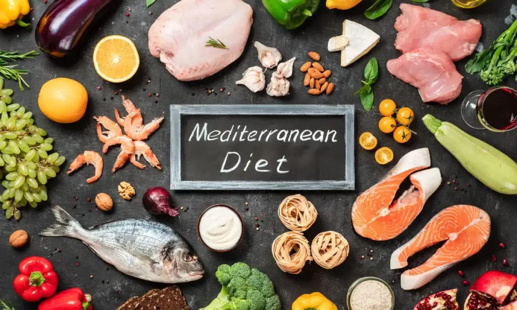 A variety of healthy foods laid out on a dark surface, highlighting components of the Mediterranean diet