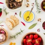 Mediterranean diet foods and ingredients placed on a white table