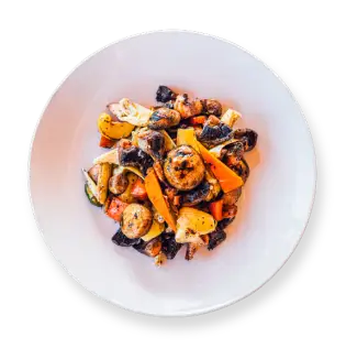 Mushroom Salad with artichokes, grilled carrots, Italian dressing, and garlic, served in a white bowl.