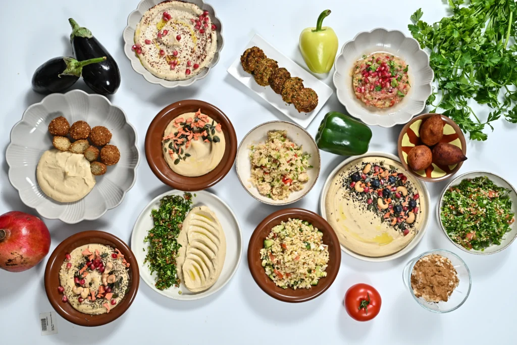 Traditional Lebanese mezze platter with hummus, tabbouleh, falafel, and fresh vegetables, showcasing the health benefits of Mediterranean food