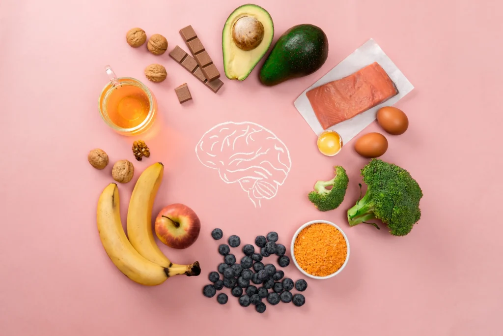 Selection of brain-boosting foods including salmon, avocado, walnuts, blueberries, and broccoli, highlighting the health benefits of Mediterranean food.