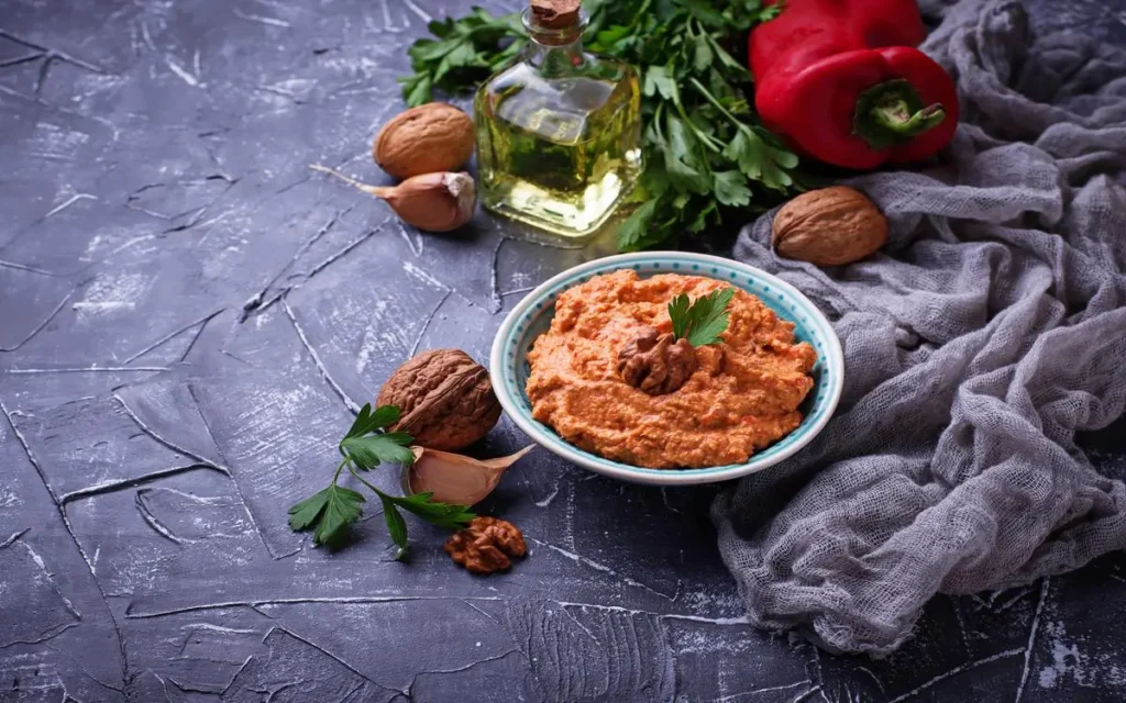 Authentic Muhammara, a mediterranean dip, made with roasted red peppers, walnuts, and olive oil.