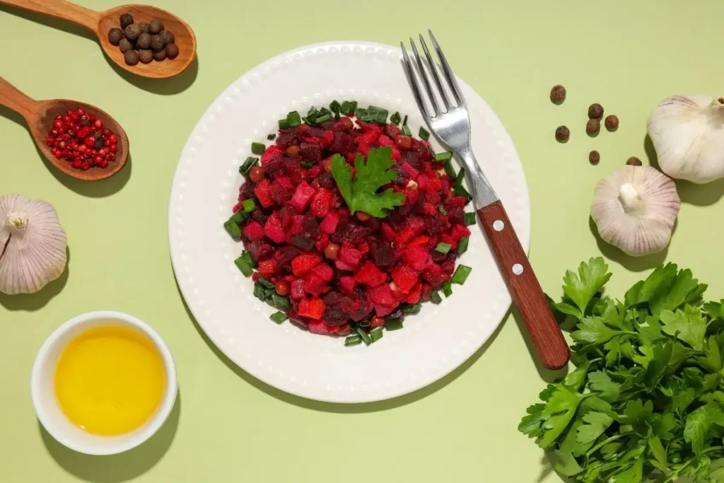 Overhead view of diced beet‑and‑jicama salad with parsley garnish on a white plate at Aladdin Mediterranean Cuisine, Houston.