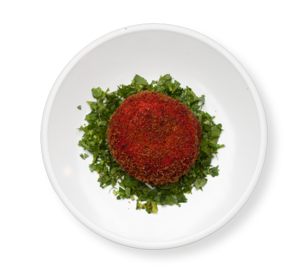 Crispy baked mashed potato served on a bed of parsley at Aladdin Mediterranean Cuisine Houston, golden and savory.