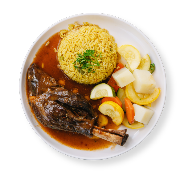 Slow-cooked lamb shank with saffron rice and steamed vegetables – Aladdin Mediterranean Cuisine Houston.