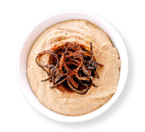 Caramelized onion hummus topped with crispy onions – creamy Mediterranean dip served at Aladdin Mediterranean Cuisine Houston