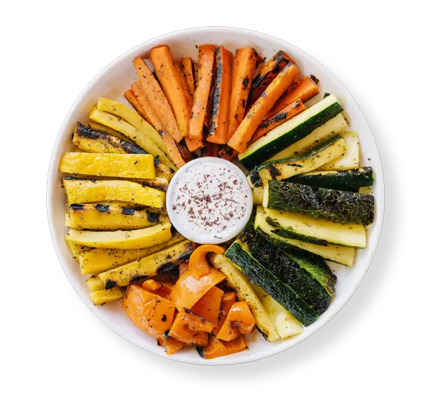 Grilled Mediterranean vegetables with zucchini, carrots, and bell peppers served with tzatziki at Aladdin Mediterranean Cuisine in Houston