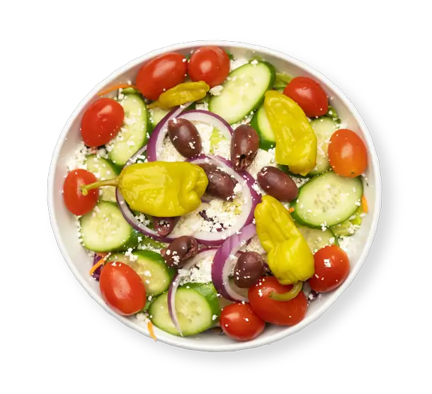 Fresh Greek salad with cucumbers, tomatoes, Kalamata olives, feta cheese, and pepperoncini peppers served at Aladdin Garden Oaks in Houston