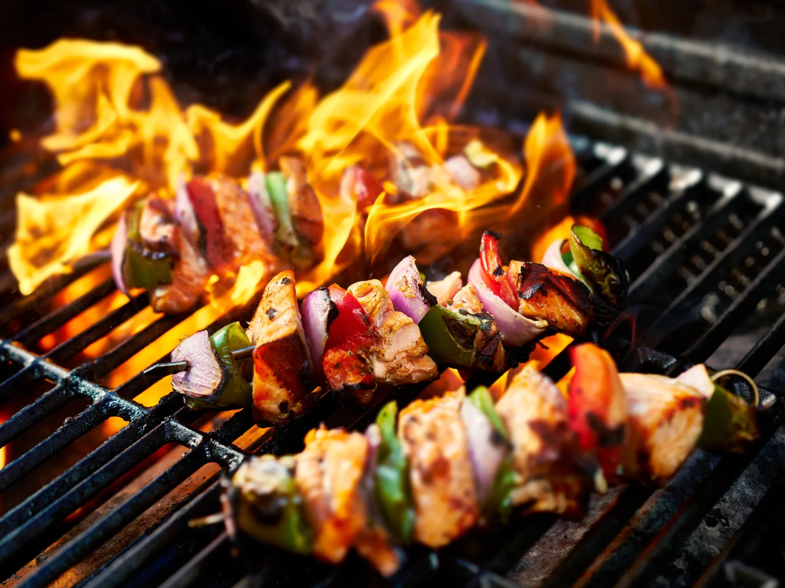 Mediterranean chicken kabob halal Houston — char-grilled skewer with peppers and onions on open flame