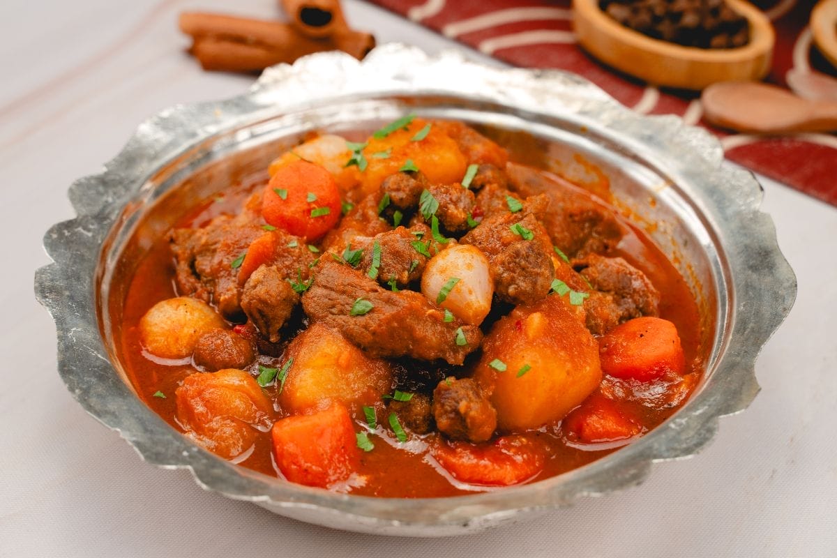 Sweet chili beef stew with lamb meatballs in a rich tomato-pepper sauce with carrots and potatoes.
